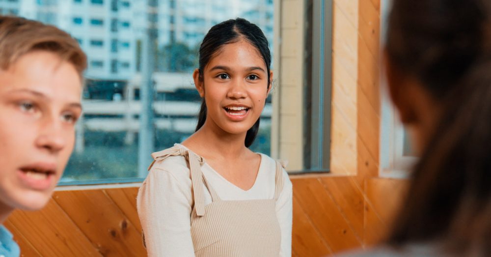 Nuoret keskustelevat yhdessä sisällä.